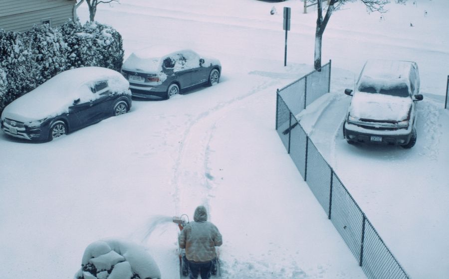 Shoveling snow from a suburban driveway