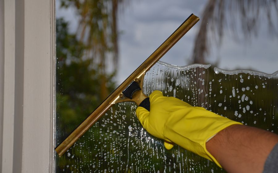 Cleaning a residential window with a squeegee