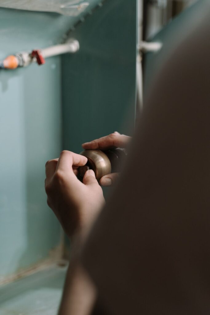 Plumbing work under a kitchen sink