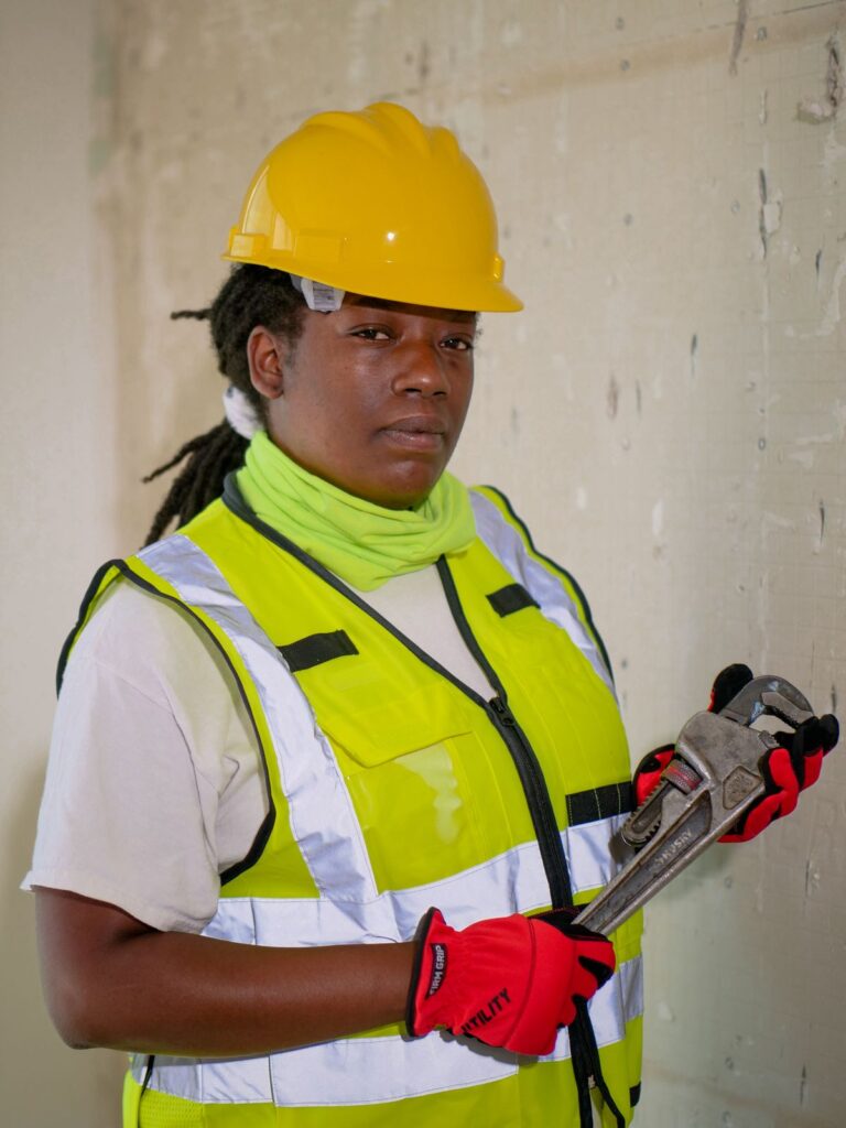 Technician with a plumbing wrench for under-sink work
