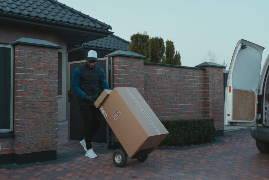 Worker moving items with a hand truck